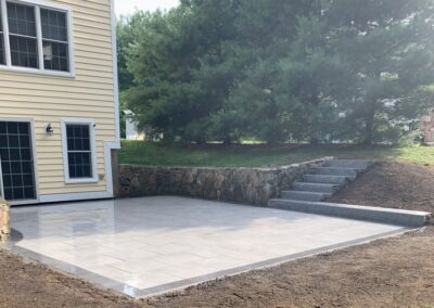 Elegant Bluestone Patio and Granite Steps in Andover, MA: Enhance your outdoor space with our expert hardscaping services. Our skilled team specializes in creating beautiful and durable bluestone patios and granite steps to elevate your property's aesthetics and functionality. Contact us today for a consultation!