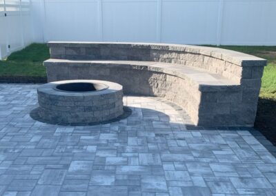 Stunning Backyard Patio with Fire Pit and Sitting Wall in Billerica, MA: Elevate your outdoor living space with our expert hardscaping services. Our skilled team specializes in creating beautiful and functional backyard retreats, complete with fire pits and sitting walls. Contact us today for a consultation!