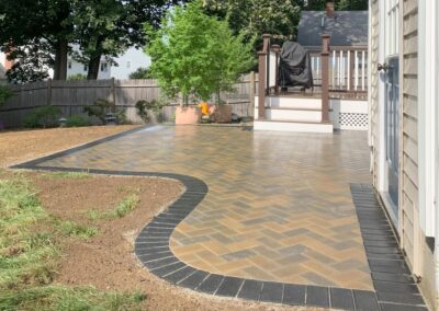 Billerica, MA Paver Patio with Dark Border: Elegant outdoor hardscape design featuring a beautifully crafted paver patio with a striking dark border, perfect for your outdoor living space.