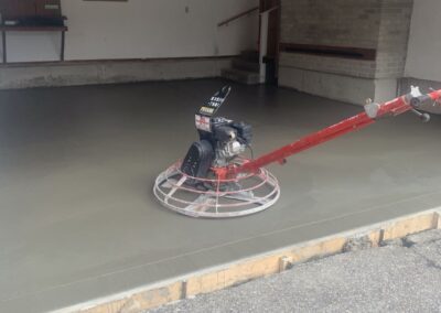 This image showcases a completed concrete garage floor installation service in Newton, Massachusetts