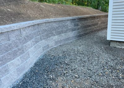 Andover, MA Interlocking Wall Installation: Professional hardscape and landscaping service in Andover, Massachusetts, showcasing expertly installed interlocking wall. Transform your outdoor space with our skilled craftsmanship.