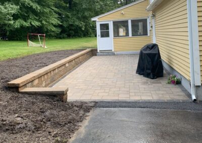 Retaining wall and paver patio installation in Andover, MA: Enhance your outdoor space with professional hardscaping services. Our expert team installs durable retaining walls and beautiful paver patios to elevate your property's aesthetics and functionality.