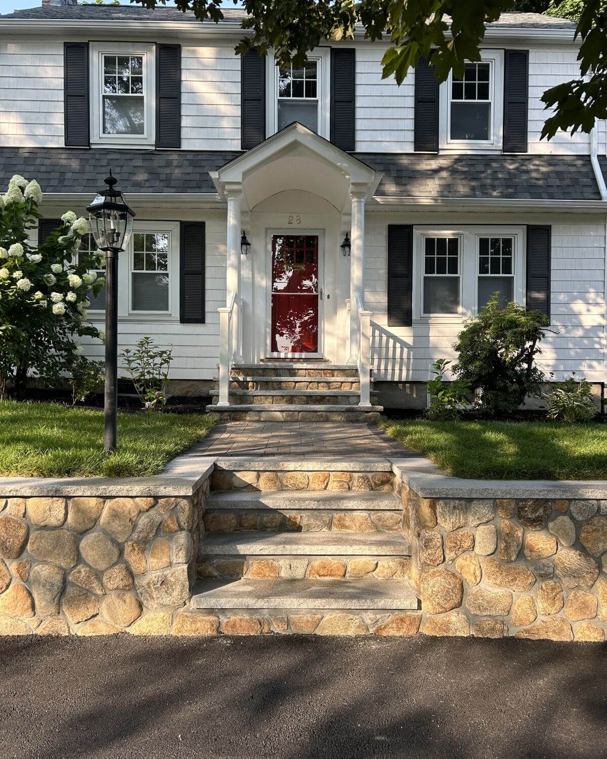 Stone retaining wall and front walkway completed by Goodwood General Construction