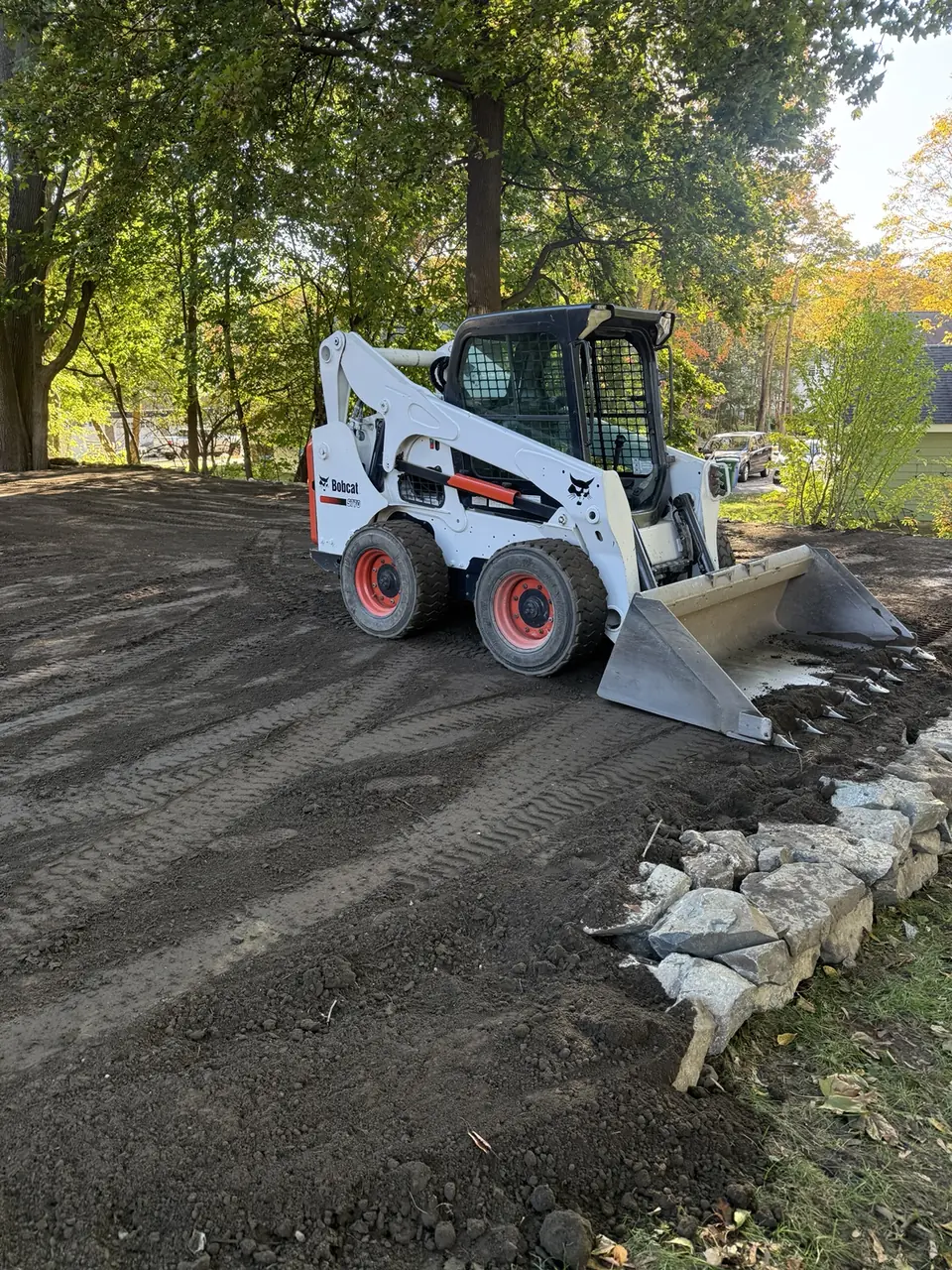 Goodwood skid-steer grading a residential property on the North Shore