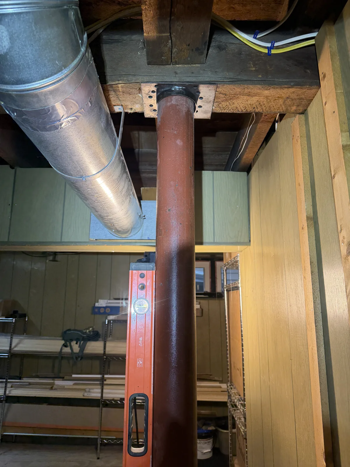 Steel Lally column and top plate beneath an existing wood beam